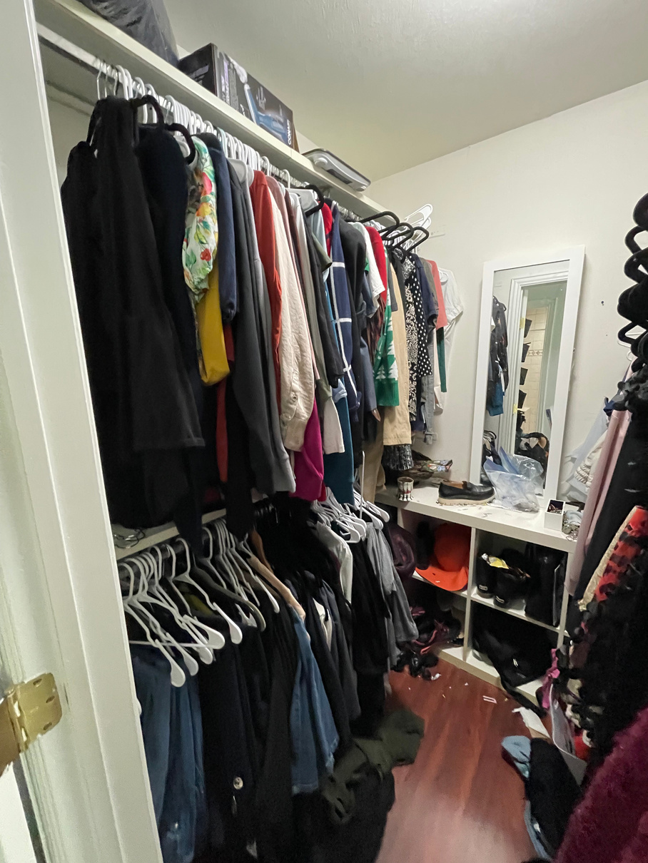 a cluttered walk-in closet with clothes and shoes ready to be decluttered by Friend to Friend Organizing